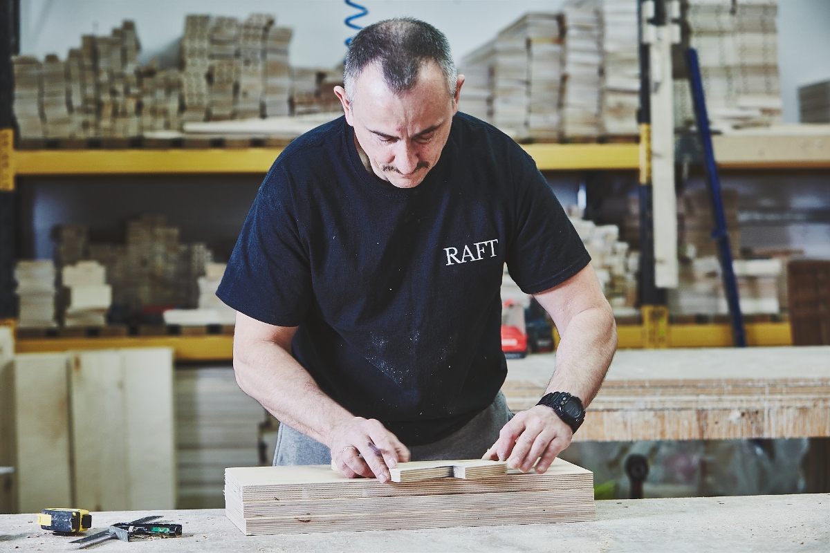 Raft sofa factory worker building a sofa frame from kiln dried hardwood in London